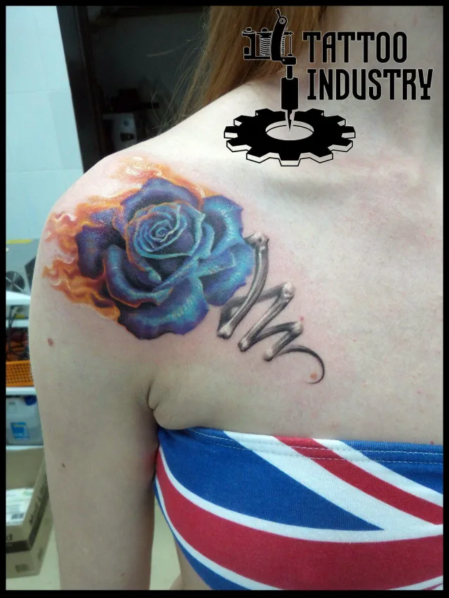 Тату роза синяя в огне на плече девушки